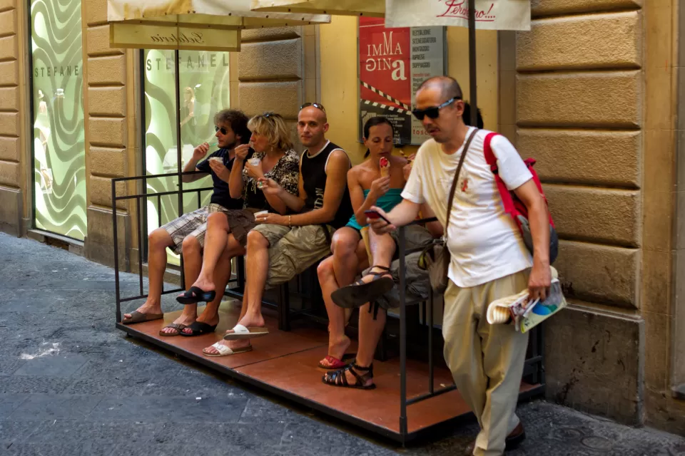 people eating ice cream on sidewalk seating